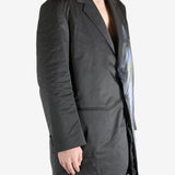 Black jacket worn by a person, showing the jacket's fit