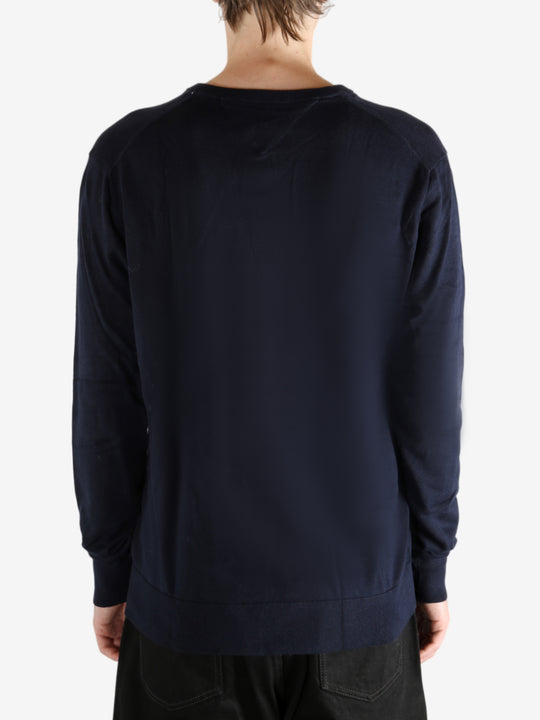 Navy sweater worn by a person, showing the sweater's fit