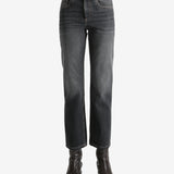 Black jeans worn by a person, showing the jean's fit