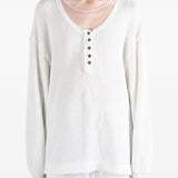 White top worn by a person, showing the top fit