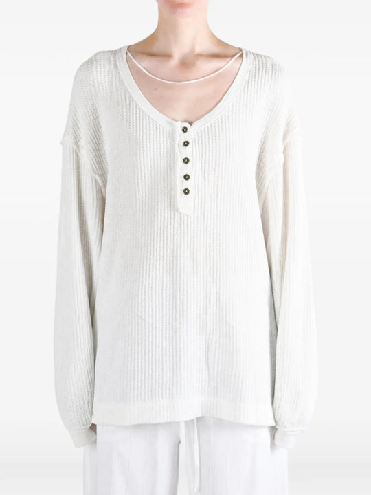 White top worn by a person, showing the top fit