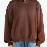 Brown sweats-hoodies worn by a person, showing the cotton fit