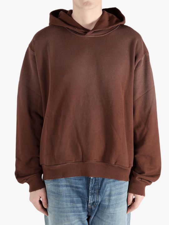 Brown sweats-hoodies worn by a person, showing the cotton fit