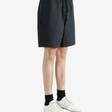 Black shorts worn by a person, showing the shorts' fit