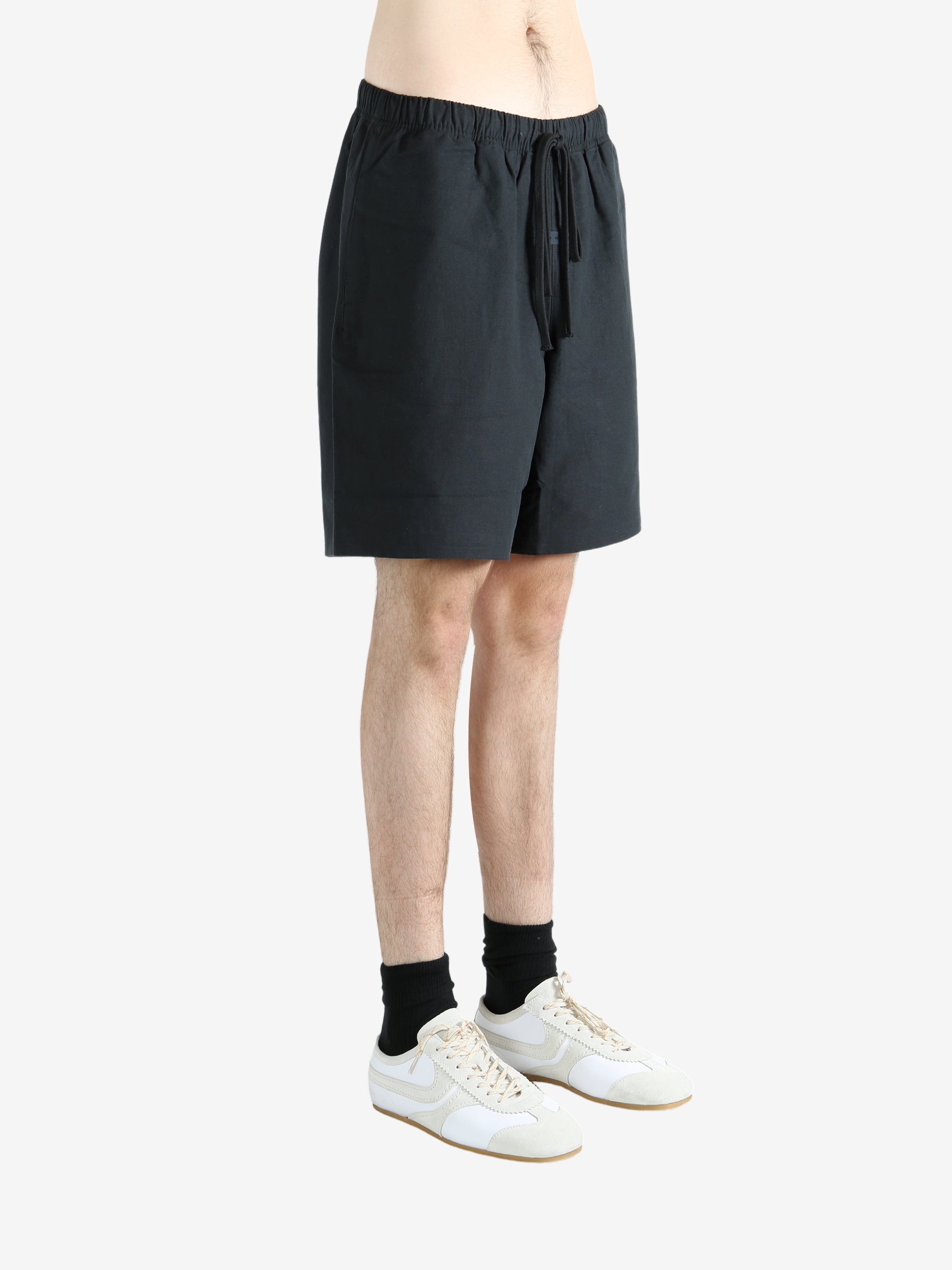 Black shorts worn by a person, showing the shorts' fit
