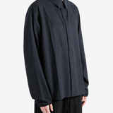 Black shirt worn by a person, showing the shirt fit