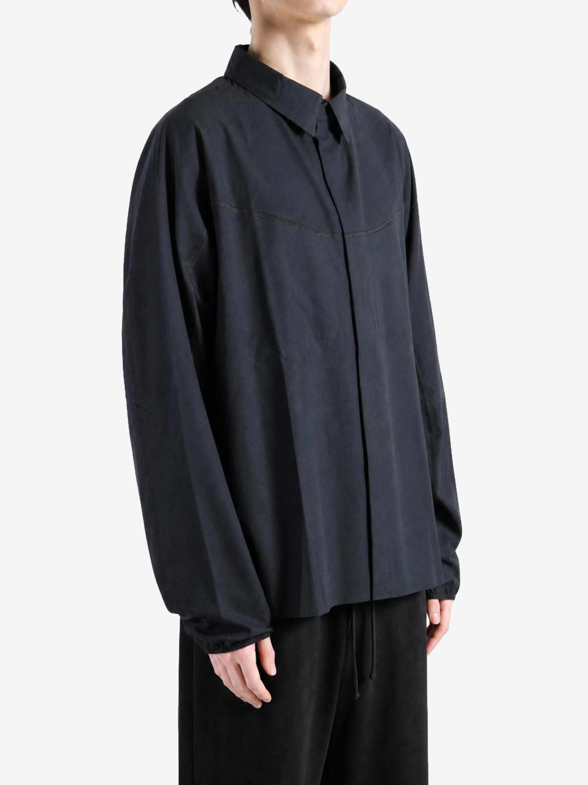Black shirt worn by a person, showing the shirt fit