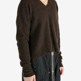 Brown knitwear worn by a person, showing the knitwear's fit
