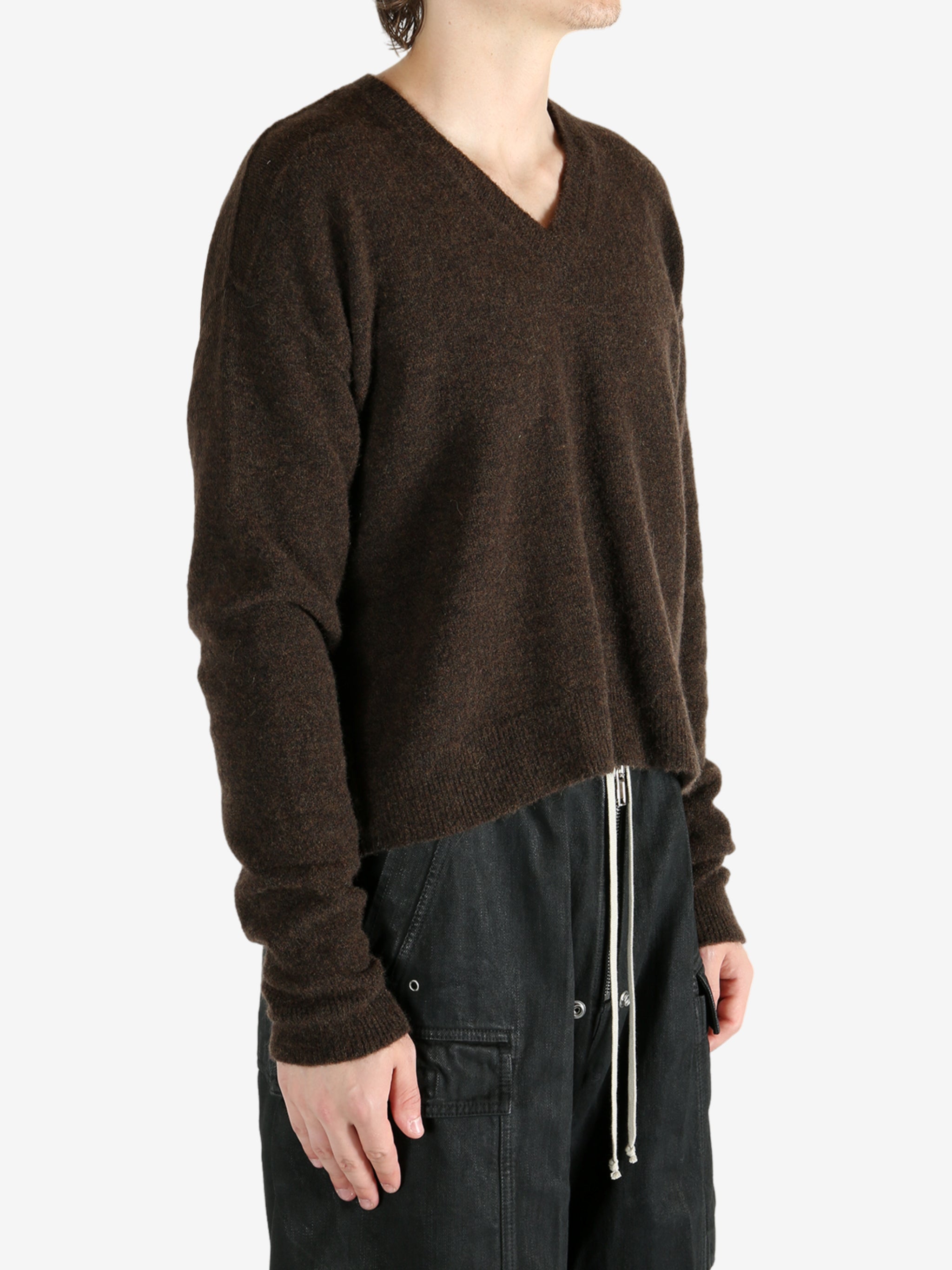 Brown knitwear worn by a person, showing the knitwear's fit