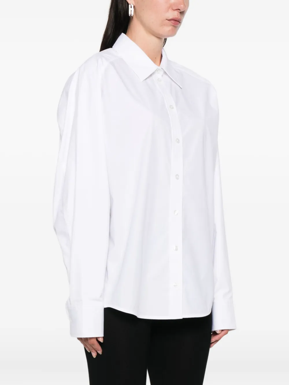 White shirt worn by a person, showing the shirt's fit