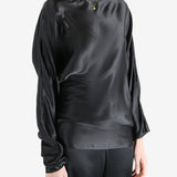 Black top worn by a person, showing the top's fit