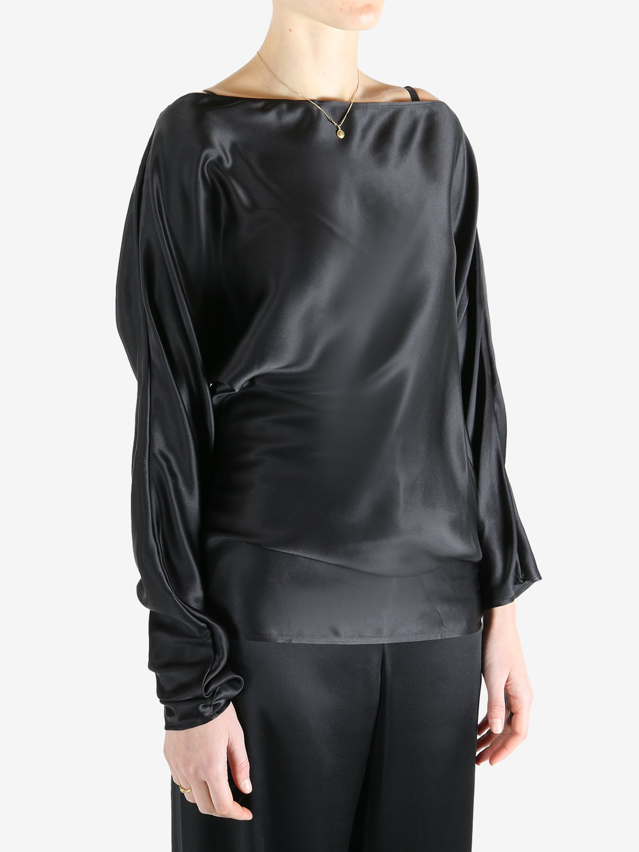 Black top worn by a person, showing the top's fit