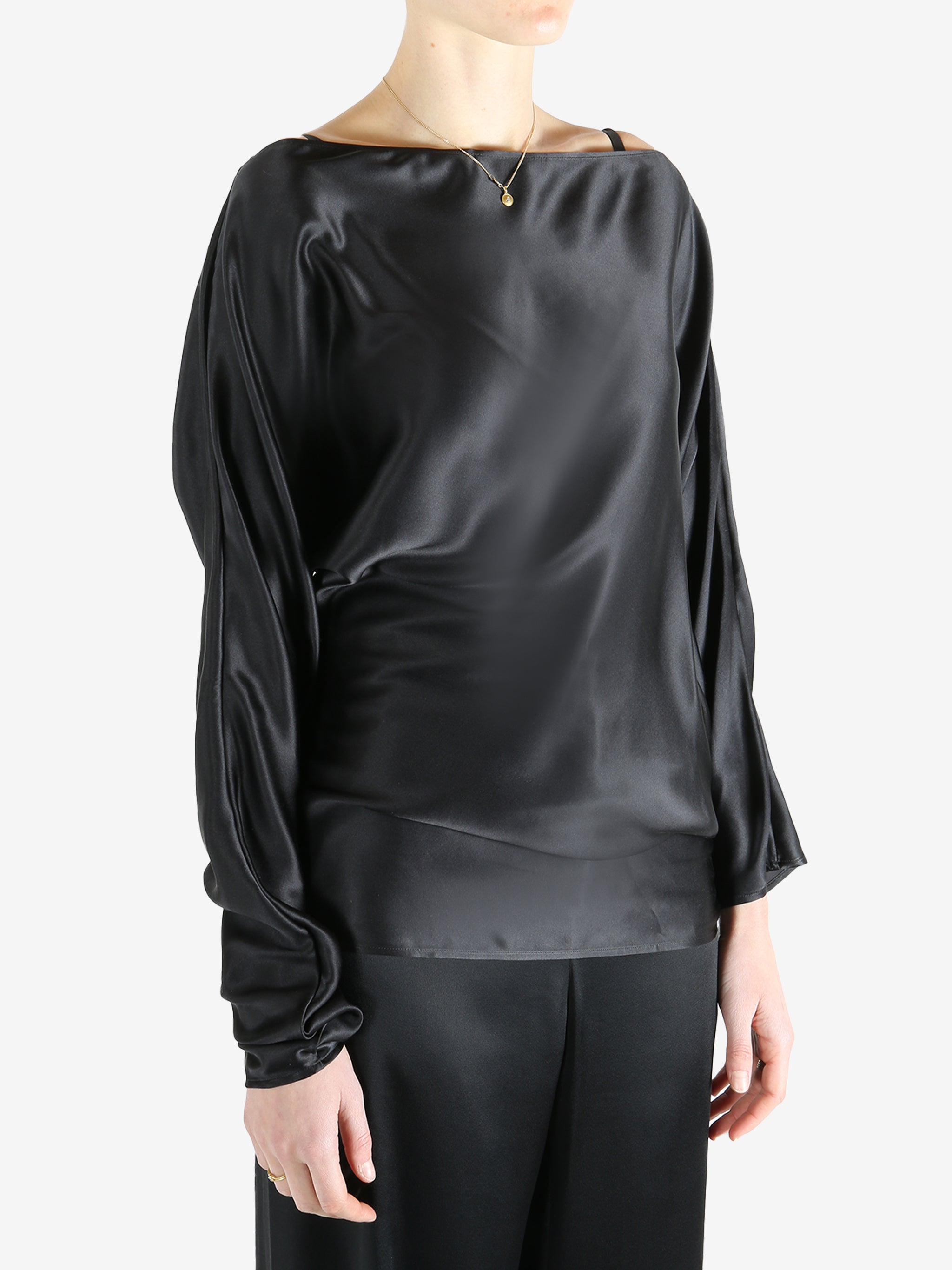 Black top worn by a person, showing the top's fit