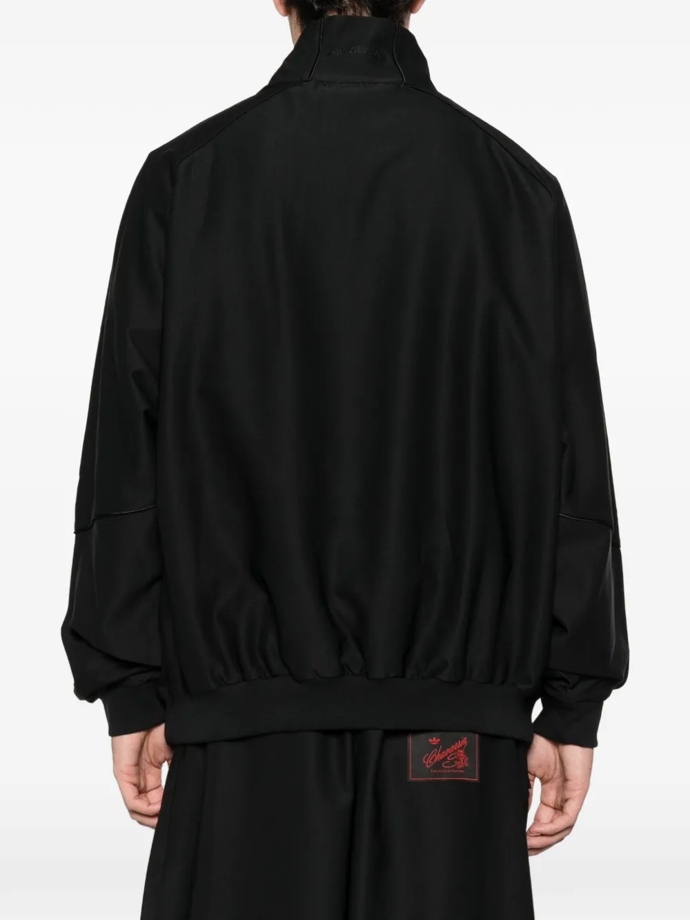 Black jackets worn by a person, showing the jackets fit