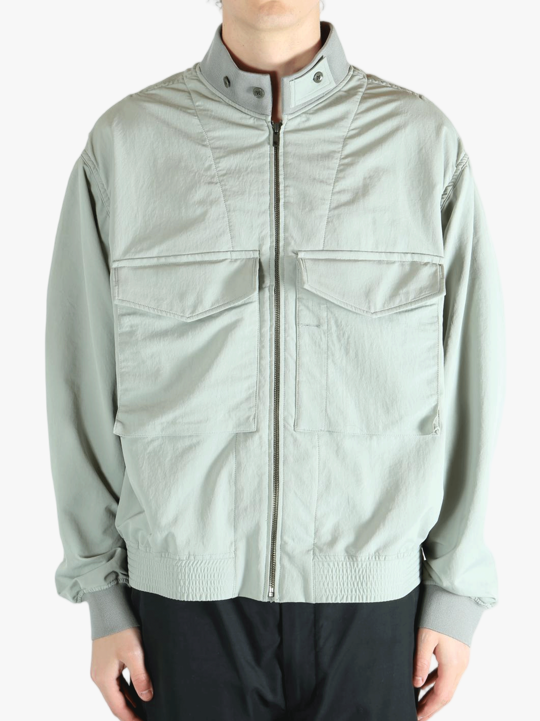 Grey jacket worn by a person, showing the jacket's fit