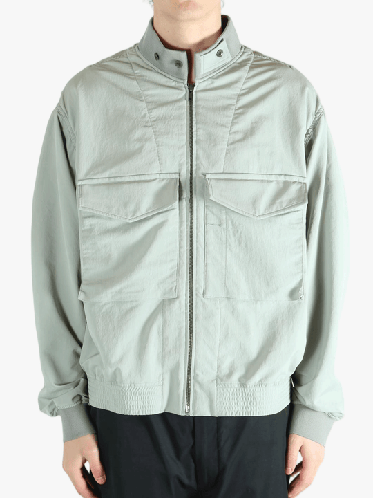 Grey jacket worn by a person, showing the jacket's fit