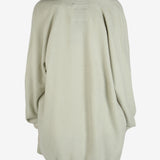 Green cardigan worn by a person, showing the cardigan fit