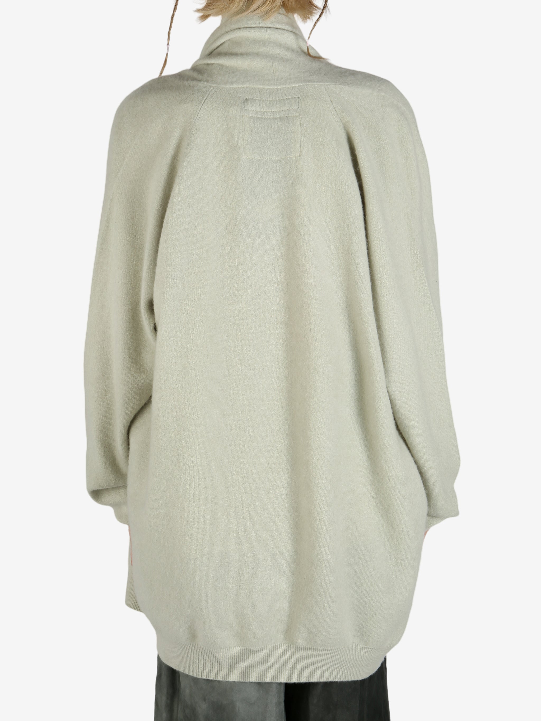 Green cardigan worn by a person, showing the cardigan fit