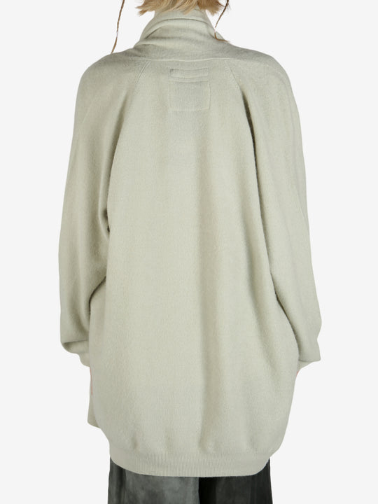 Green cardigan worn by a person, showing the cardigan fit