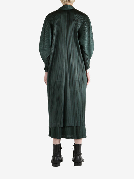 Green coat worn by a person, showing the coat's fit