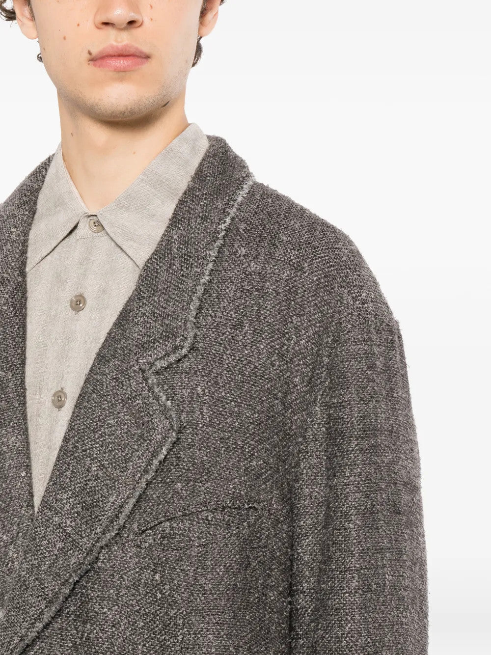 Grey blazer worn by a person, showing the blazer fit