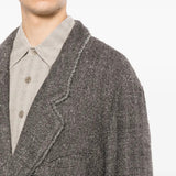 Grey blazer worn by a person, showing the blazer fit