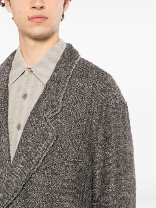Grey blazer worn by a person, showing the blazer fit