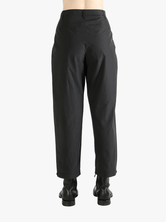 Black pants worn by a person, showing the pants fit