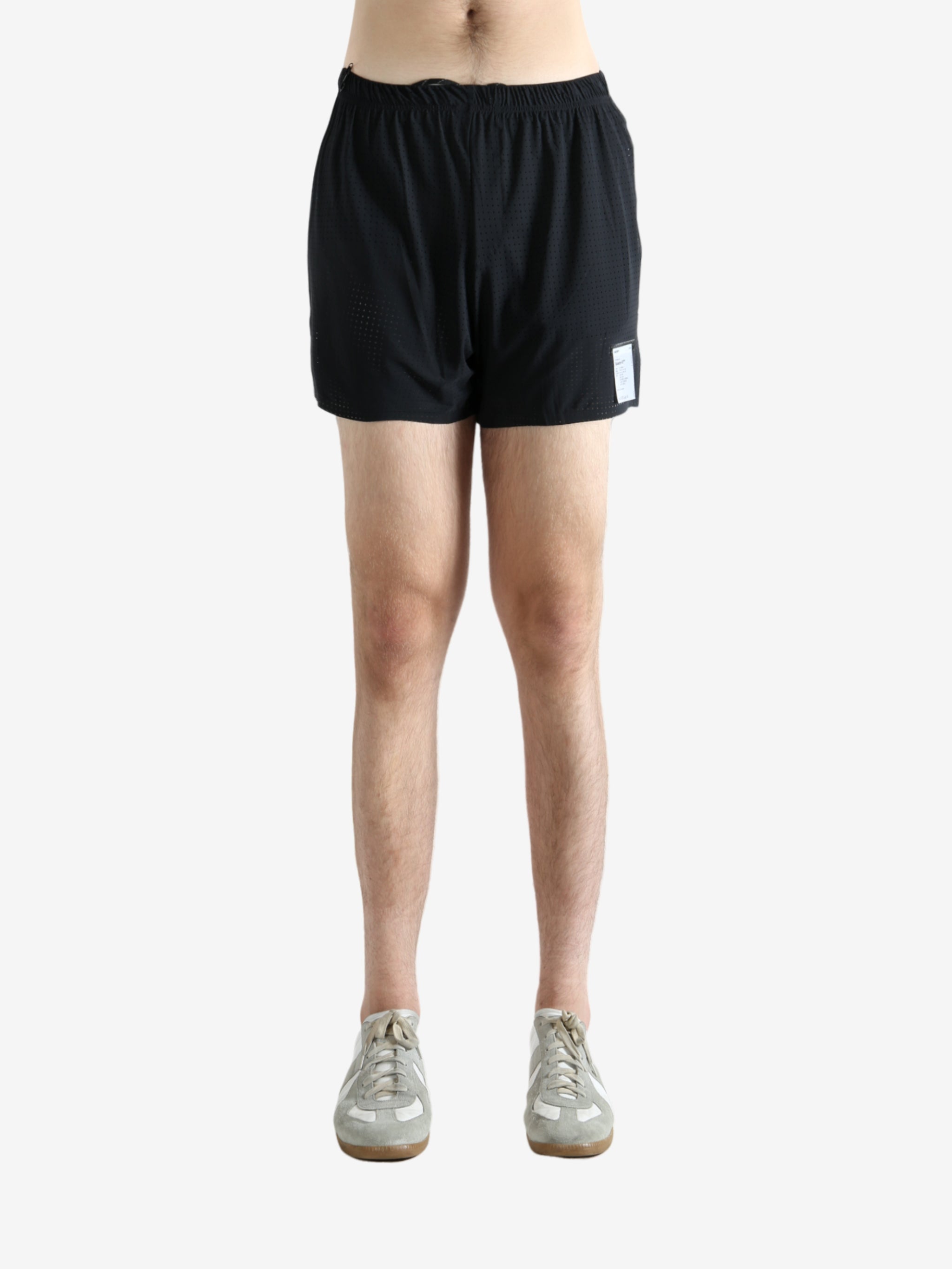 Black shorts worn by a person, showing the shorts' fit
