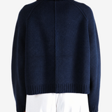 Navy knitwear worn by a person, showing the knitwear fit