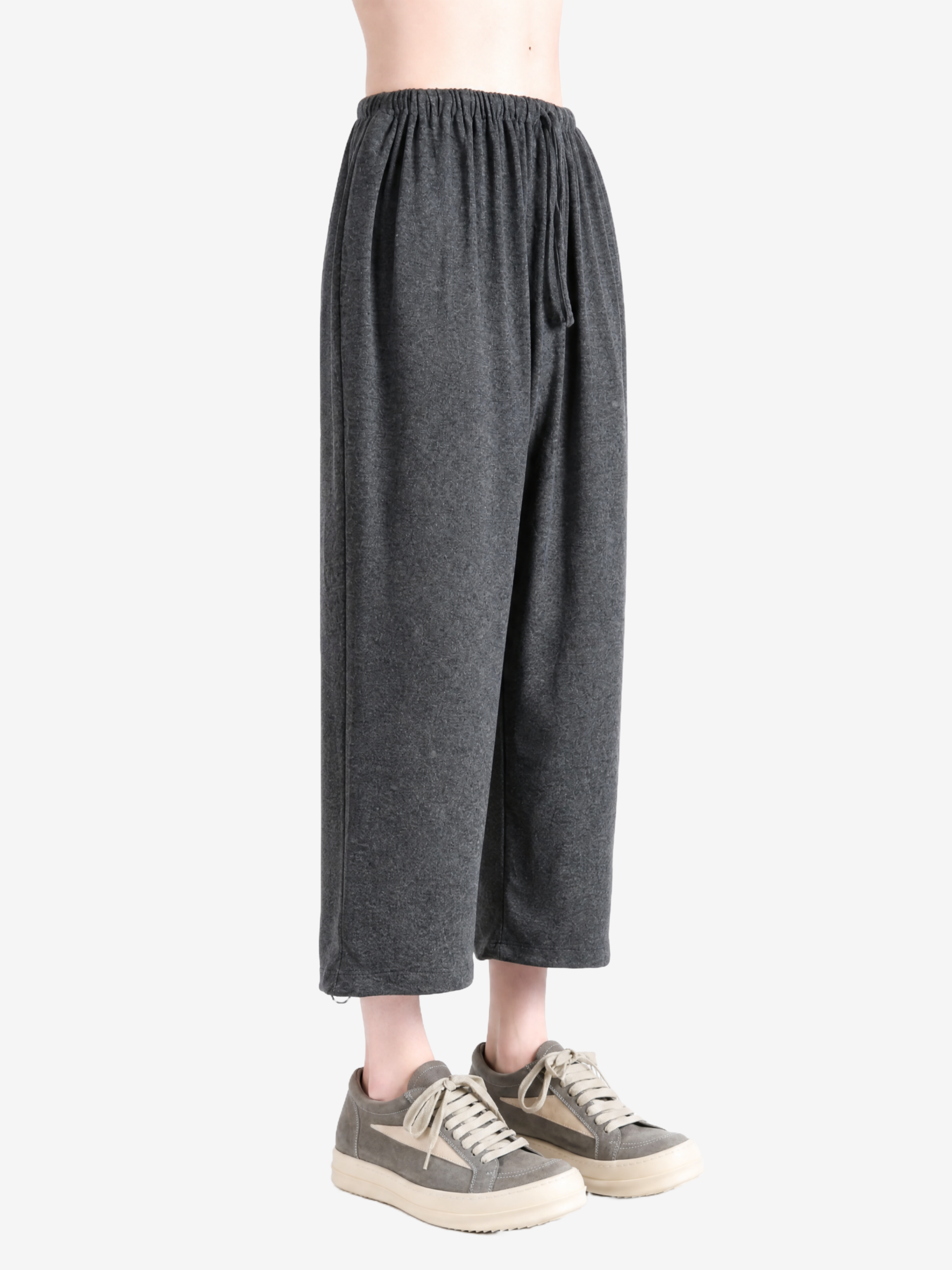 Grey pants worn by a person, showing the pants fit