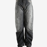 Black jeans worn by a person, showing the jeans fit