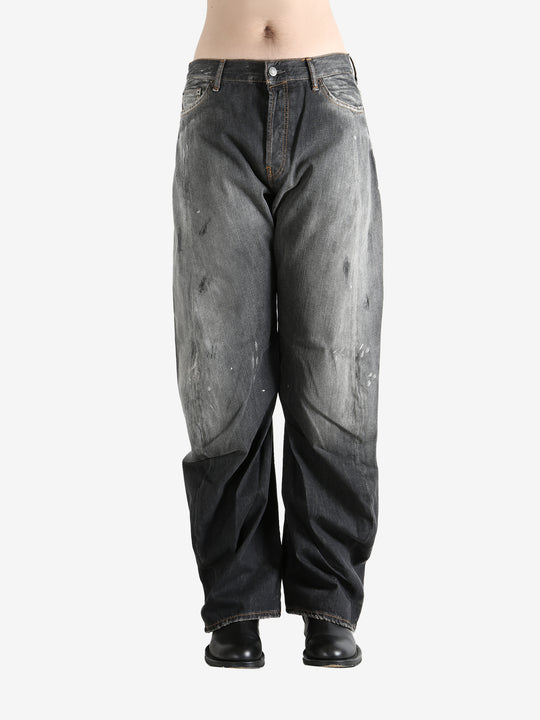 Black jeans worn by a person, showing the jeans fit