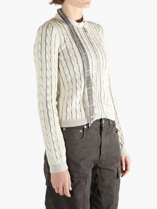 White knit long sleeve worn by a person, showing the loose fit.