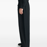 black pants worn by a person, showing the pants fit