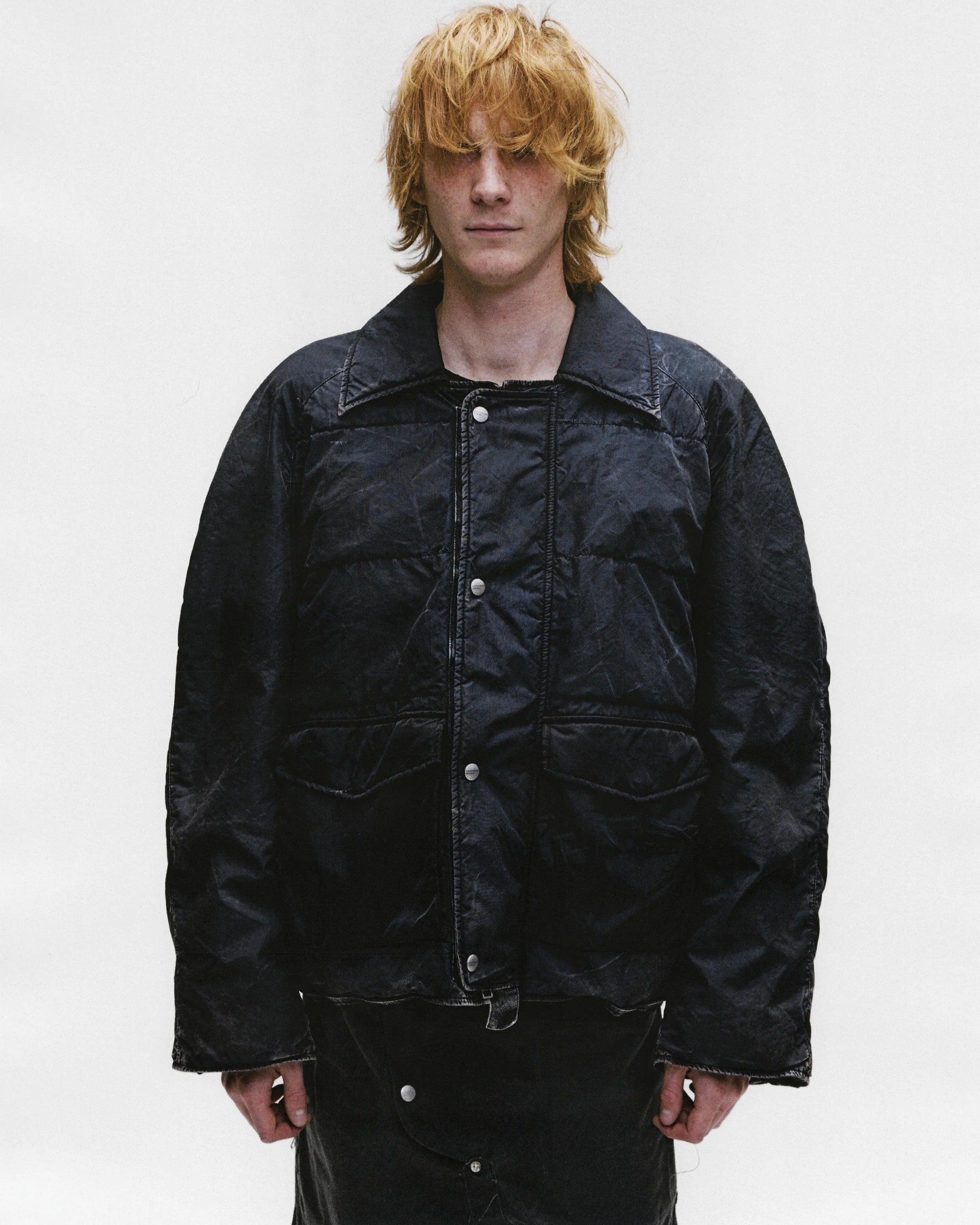 Black jacket worn by a person, showing the jacket's fit