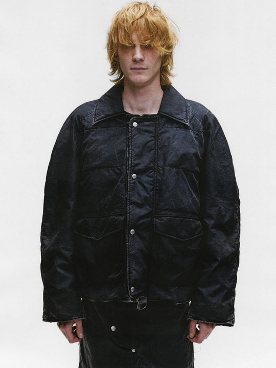 Black jacket worn by a person, showing the jacket's fit