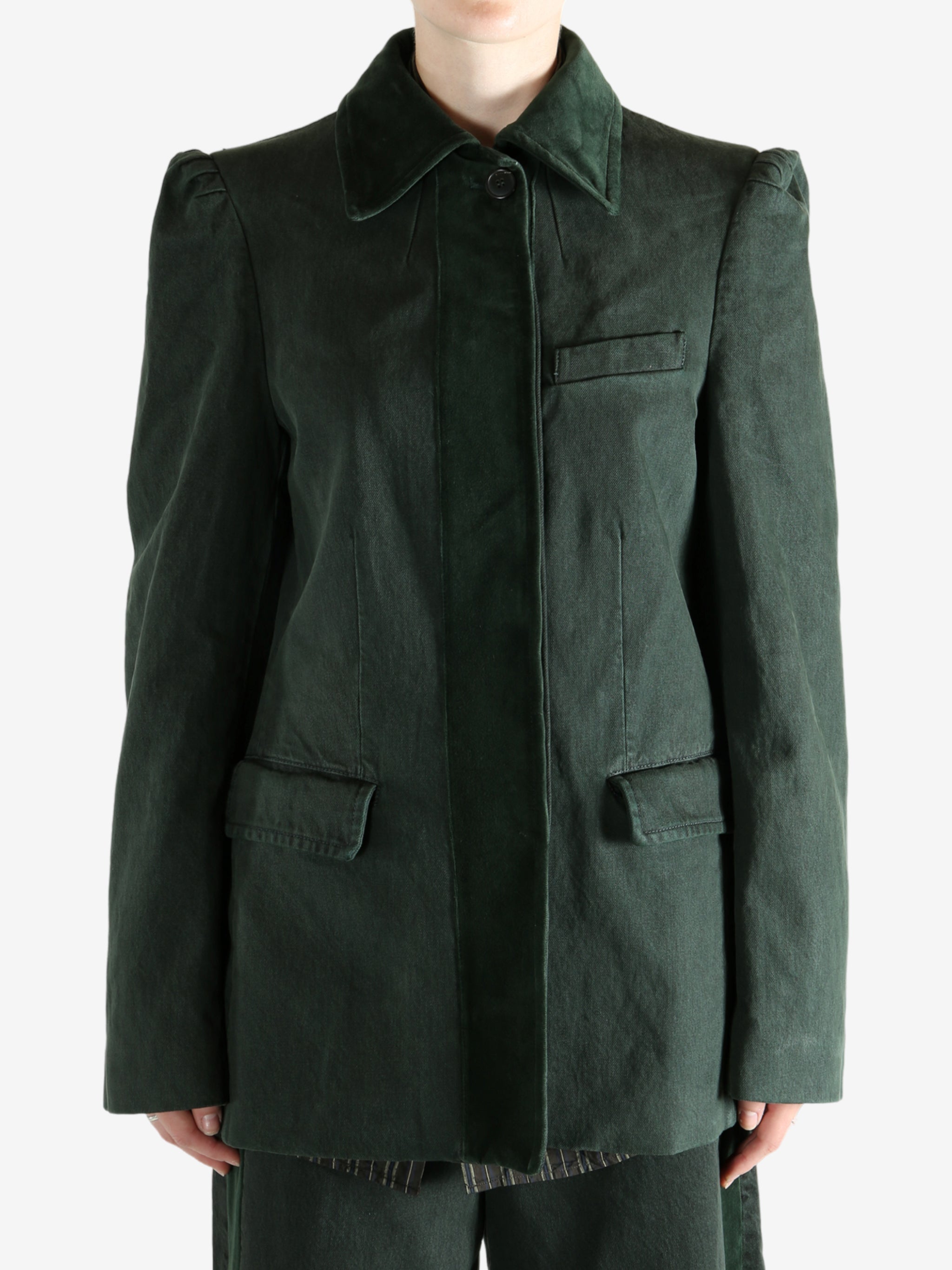 Green jacket worn by a person, showing the jacket's fit