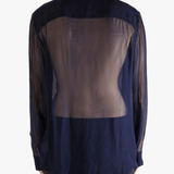 Navy blue shirt worn by a person, showing the shirt's fit