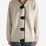 White knitwear worn by a person,showing the knitwear's fit