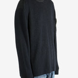 Black sweater worn by a person, showing the sweater fit
