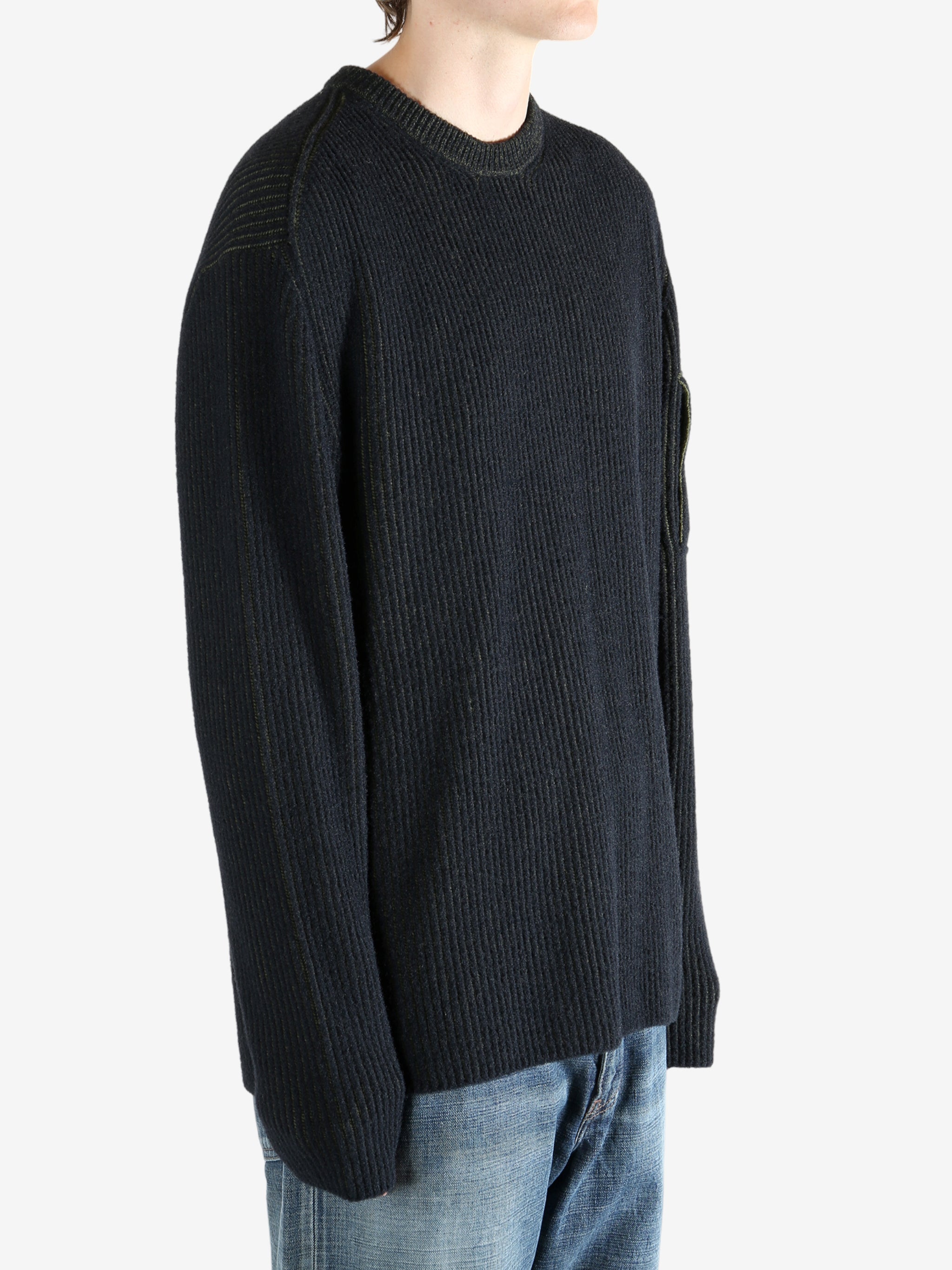 Black sweater worn by a person, showing the sweater fit