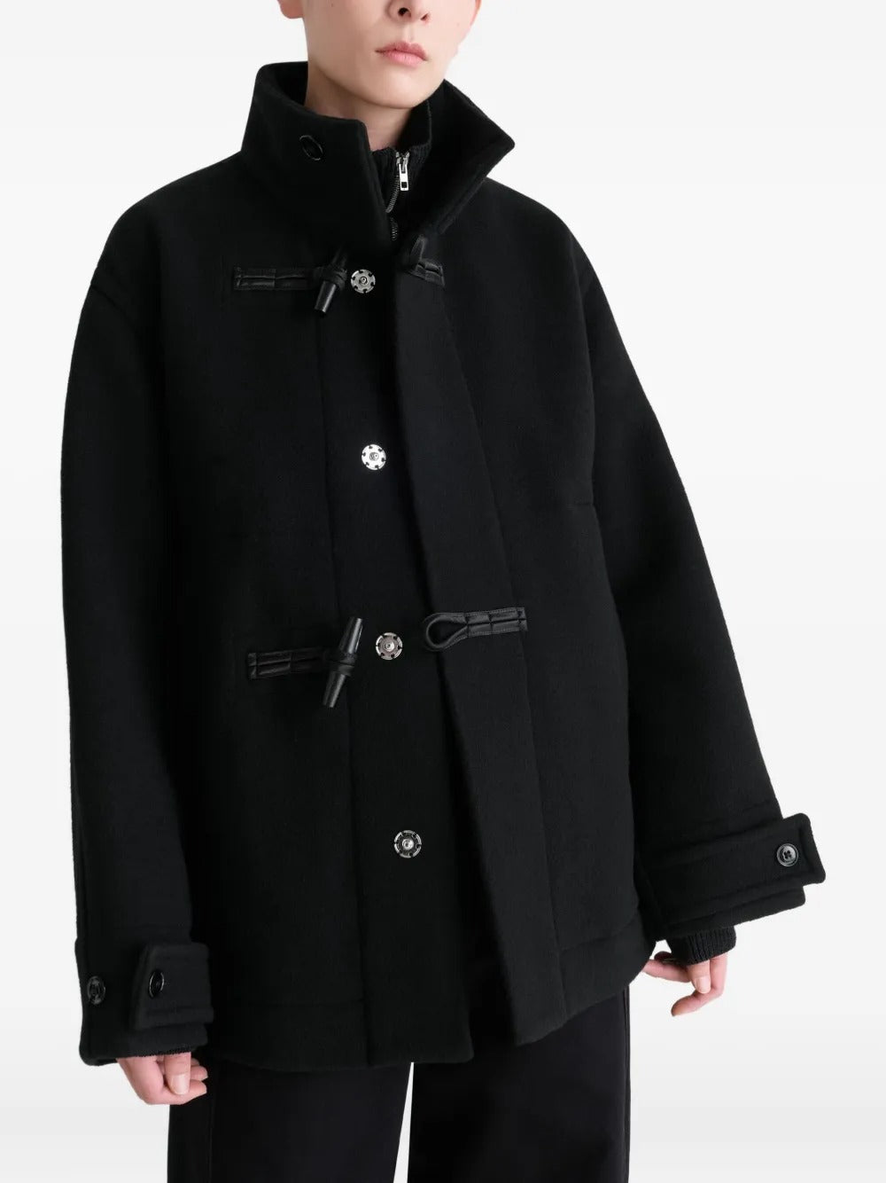 Black coat worn by a person, showing the coat's fit