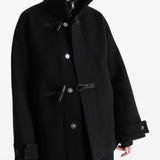 Black coat worn by a person, showing the coat's fit