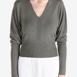 Grey top worn by a person, showing the top fit