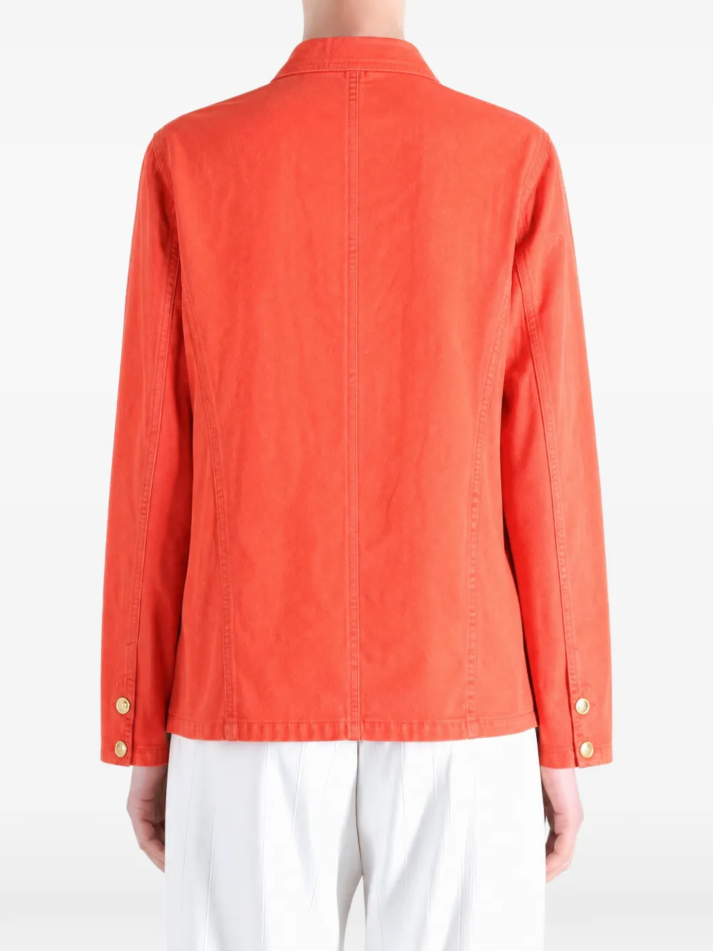 Orange jacket worn by a person, showing the jacket fit