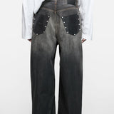 Black jeans worn by a person, showing the jeans fit