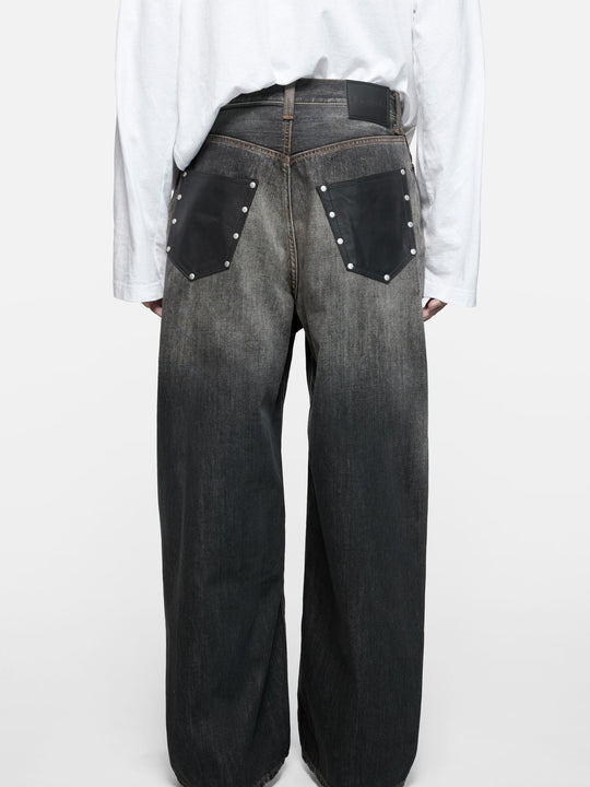 Black jeans worn by a person, showing the jeans fit
