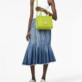 Green bag worn by a person, showing the bag's fit