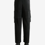 Black pants worn by a person, showing the pant's fit